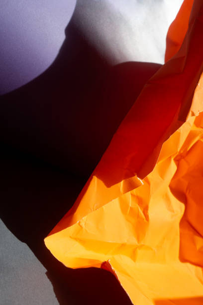 istock Wrinkled orange papers on gray background 1138596816