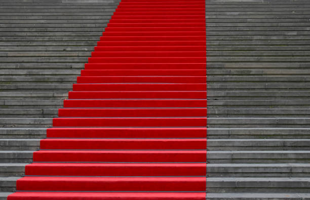 istock Red carpet over concrete stairs perspective 1138597485