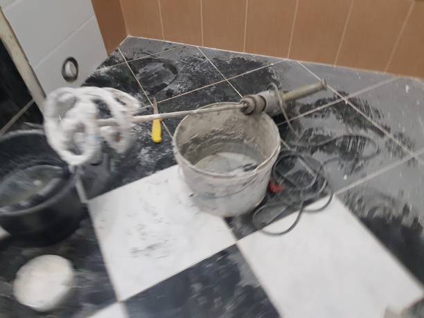 Repair - a large drill or mixer for plaster on the tiled floor