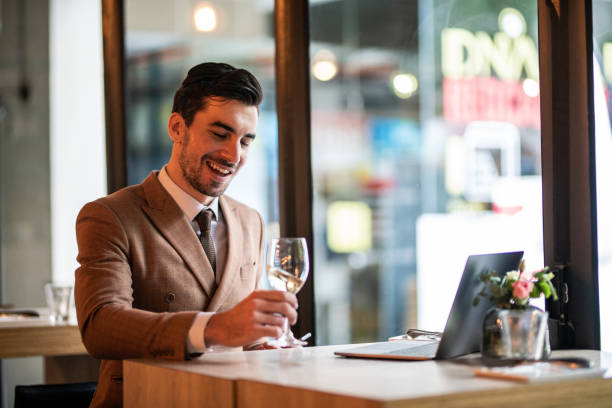 istock Cheerful businessman using laptop in restaurant 1138600315