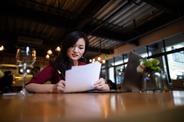 istock Chinese businesswoman signing documents in restaurant 1138600391