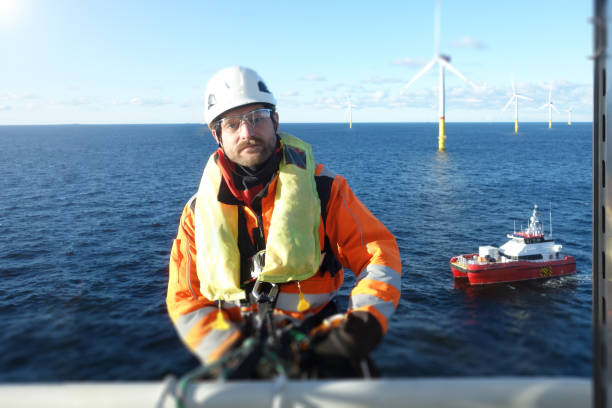 istock Manual high worker offshore preparing for rappelling down from offshore platform 1138600447