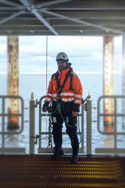 istock Rope access technicia preparing for work on offshore platform in wet-suit 1138600526