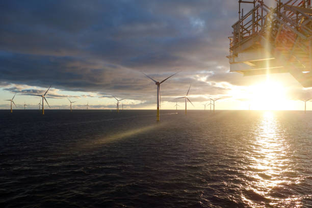 Epic view from offshore wind turbine - wind-farm im sun set stock photo