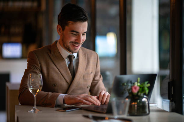 istock Cheerful businessman using laptop in restaurant 1138600585