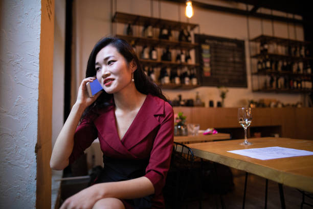 istock Chinese woman talking on smart phone 1138600611