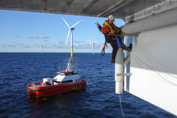 istock Rope access technician making inspection, repairing on offshore platform with transfer vessel guarding 1138600681