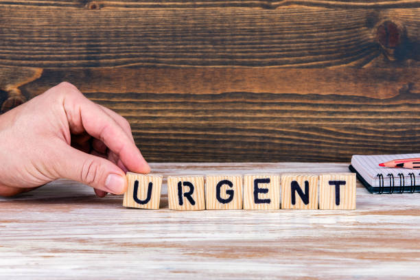 istock Urgent. Wooden letters on the office desk 1138604176
