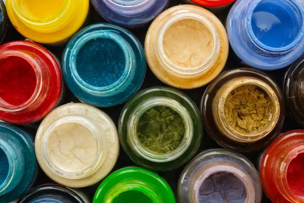 Colorful stained glass paints or oil, acrylic paints close up, top view.