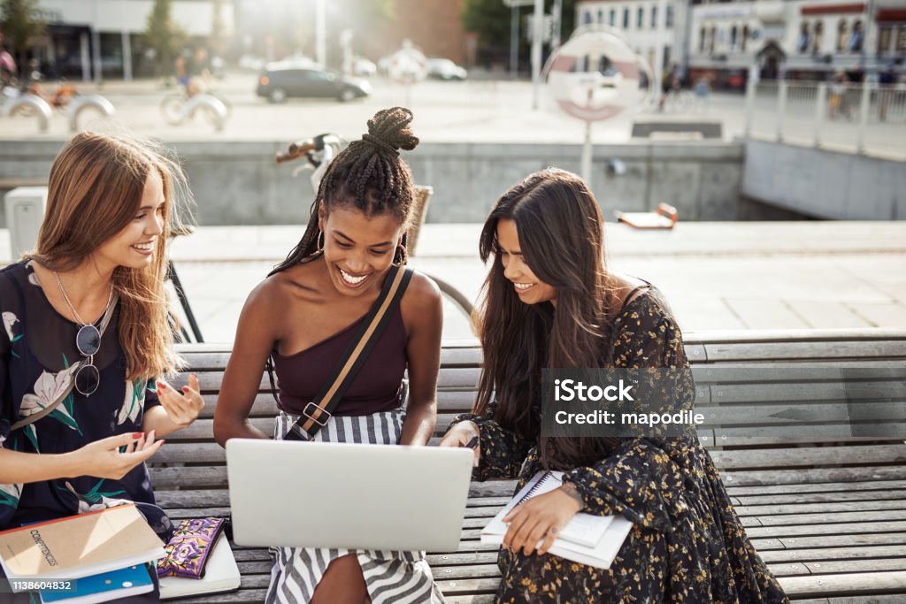 And the exam results are in! Shot of young women studying together outdoors Student Stock Photo