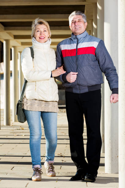 istock Married couple goes for walk between concrete pillars 1138606700