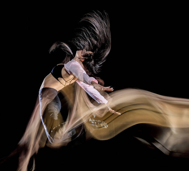 istock young woman modern dancer dancing isolated black background light painting 1138610490