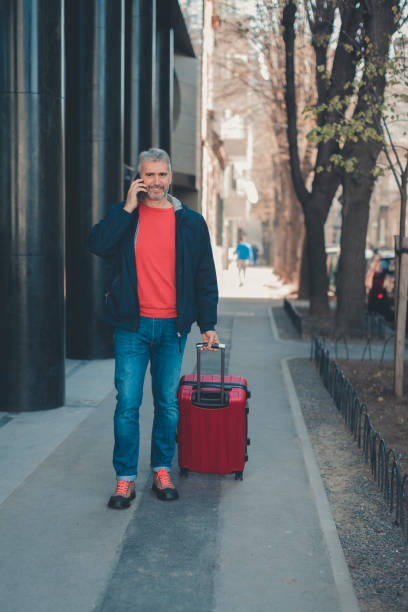 istock businessman with suitcase walking  in a city. 1138610611