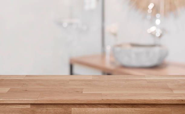 istock Defocused bathroom interior background with wooden table top in front 1138612408