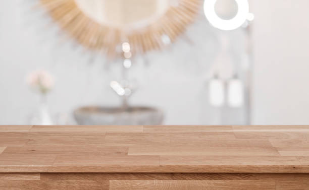 istock Blurred bathroom sink interior background with wooden table in front 1138612452