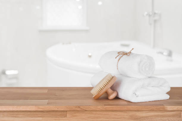 istock White spa towels on wooden table over defocused bathroom background 1138612708