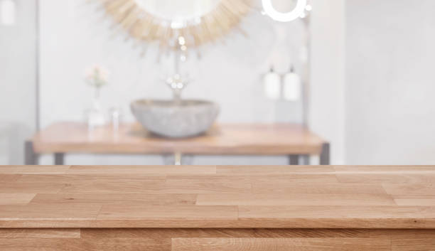 istock Wooden table in front of blurred bathroom sink interior background 1138613622