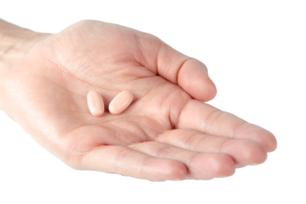 istock pills in woman hand 1138615188
