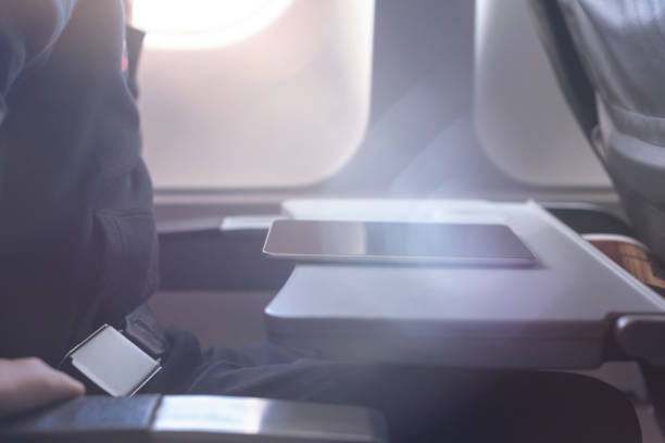 istock Caucasian boy fasten seat belt and using tablet pc during air flight.  Safety travel with kid. concept 1138615530