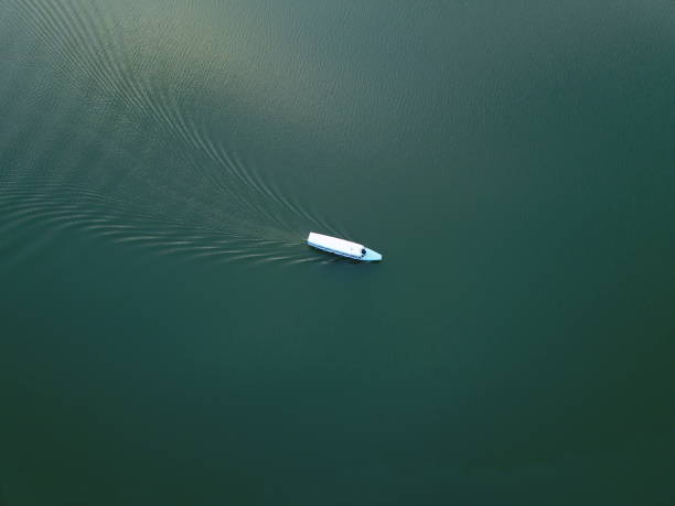 istock long boat on green lake 1138615592