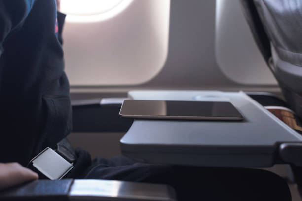 istock Caucasian boy fasten seat belt and using tablet pc during air flight.  Safety travel with kid. concept 1138615909