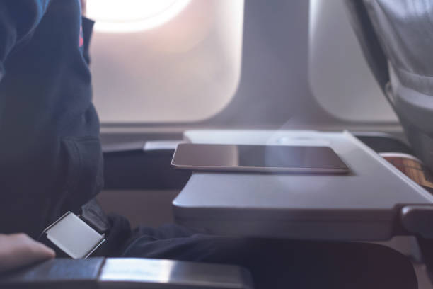 istock Caucasian boy fasten seat belt and using tablet pc during air flight.  Safety travel with kid. concept 1138615932