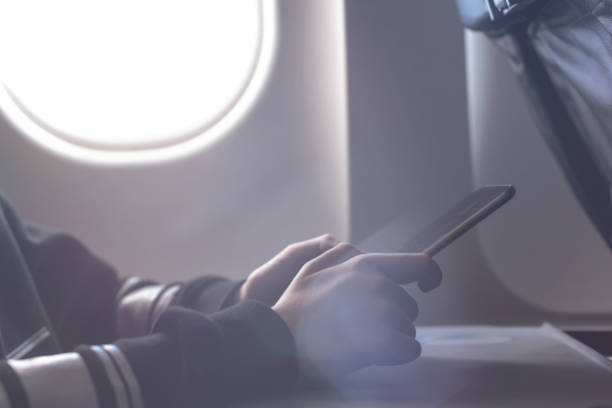 istock Caucasian boy fasten seat belt and using tablet pc during air flight.  Safety travel with kid. concept 1138616082