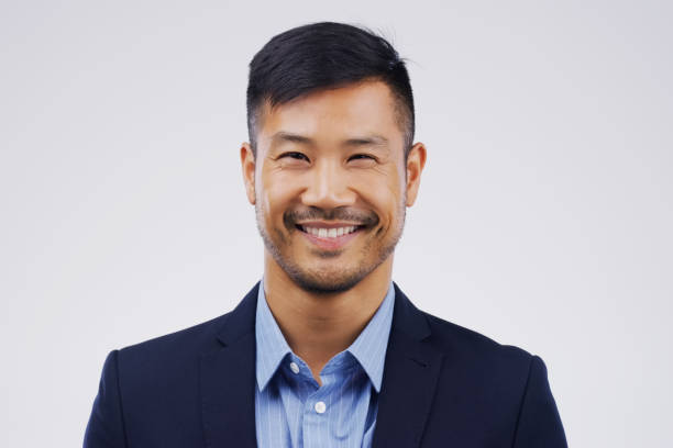 I'm happy with where my career is heading Studio portrait of a handsome young man posing against a grey background headshot stock pictures, royalty-free photos & images