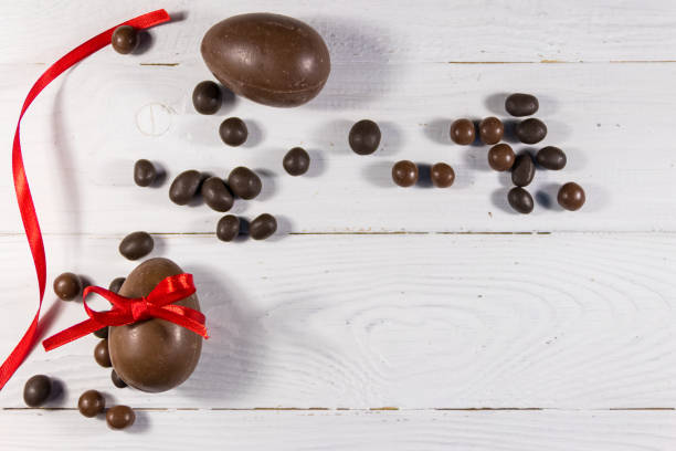 istock Easter composition with chocolate eggs on white wooden background 1138618593