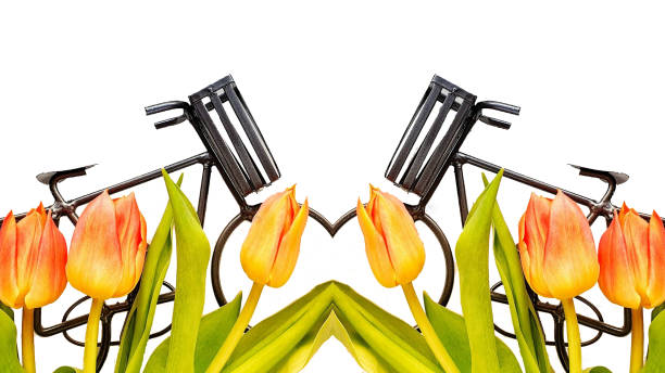 A bouquet of yellow tulips is scattered on a light surface. Nearby are decorative candles. Close-up, top view.