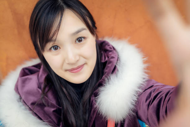 Portrait of beautiful Asian girl child in traditional dress celebrates Chinese new year.