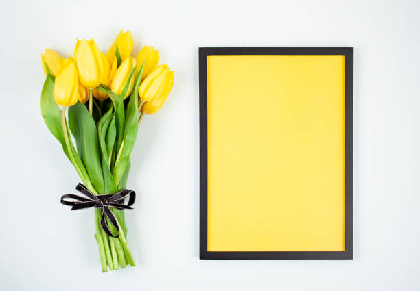 istock Decorative empty frame with copy space and bouquet of tulips 1138618988