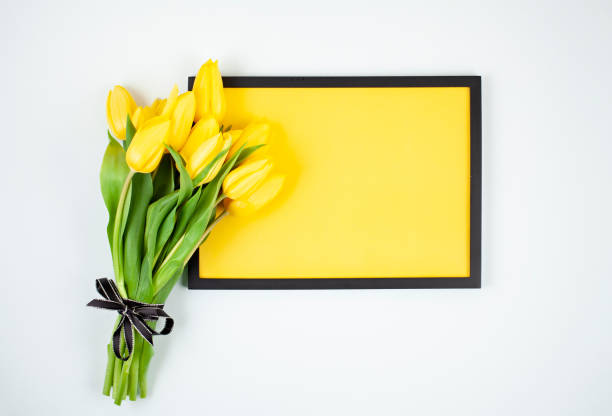 istock Decorative empty frame with copy space and bouquet of tulips 1138619007