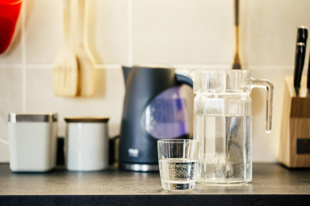 istock Glass of pure water on kitchen table. 1138619742