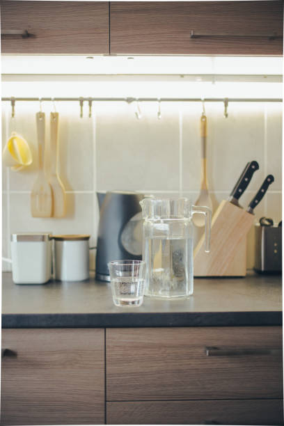 istock Glass of pure water on kitchen table. 1138619750
