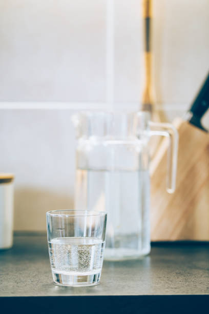 istock Glass of pure water on kitchen table. 1138619754