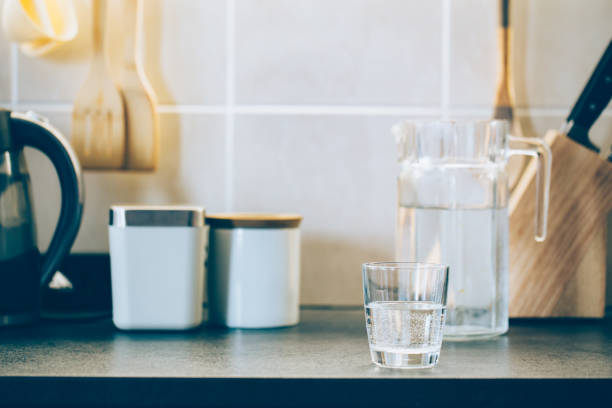 istock Glass of pure water on kitchen table. 1138619757