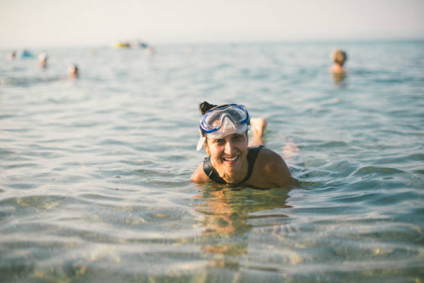 istock Woman having fun while diving in the sea 1138623646
