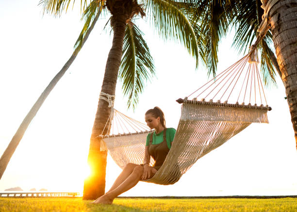 istock girl in a hammock tropical palm trees  at sunset 1138623947