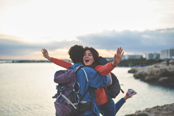 istock Cheerful young tourists having fun near water 1138627595