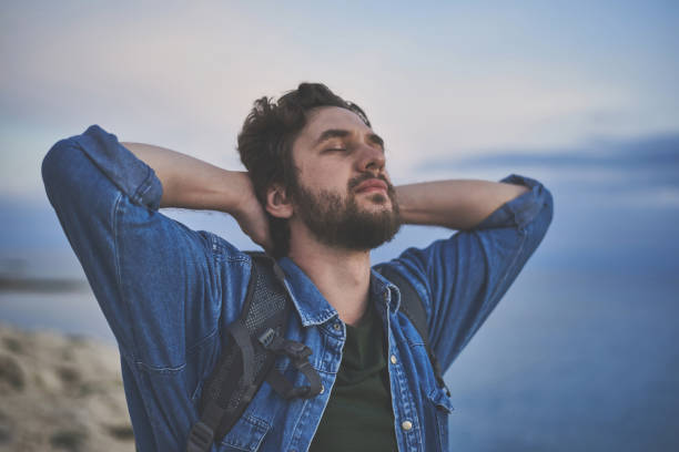 istock Peaceful guy breathing fresh air at the seaside 1138627667