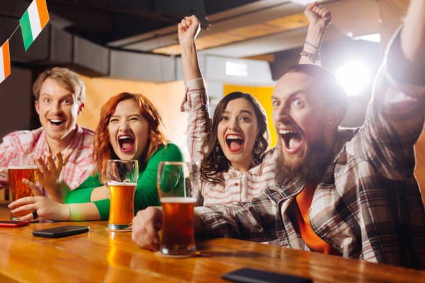istock Two couples feeling emotional while watching football n the bar 1138629901