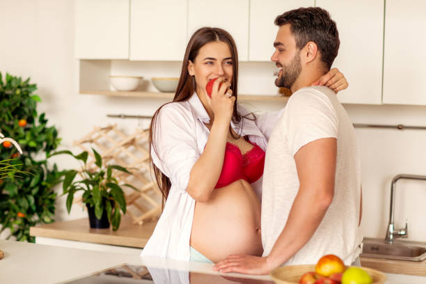istock pregnant couple standing in their kitchen preparing 1138631133
