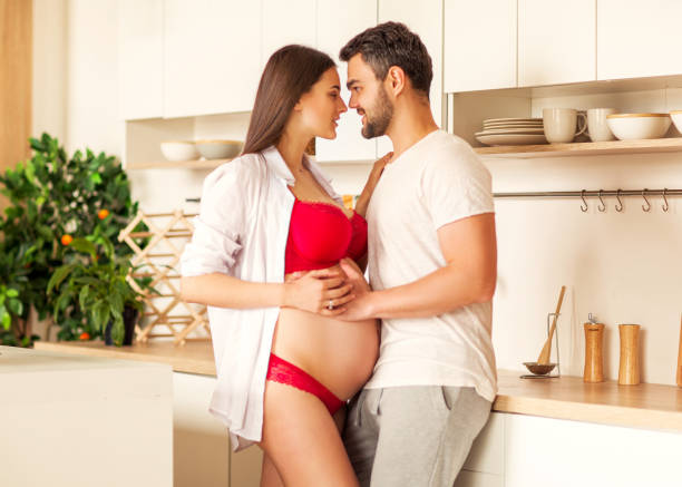 istock pregnant couple standing in their kitchen preparing 1138631136