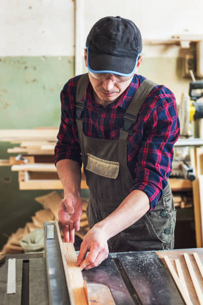 istock Carpenter worker cutting wooden board 1138633886