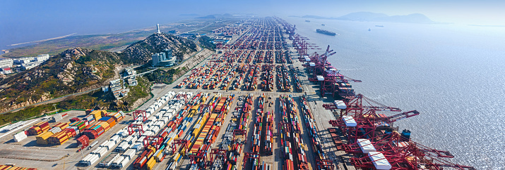 Aerial view of Shanghai Yangshan Port on Yangshan Island with container ships, cranes and containers