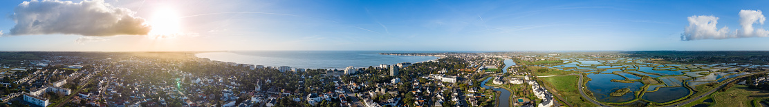Drone panorama of La Baule Escoublac with seaside, beach and salt marshes in Britanny, France