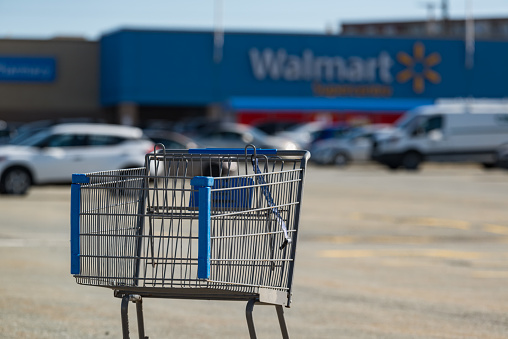 March 26, 2019 - Halifax, Canada - A shopping cart sits in the foreground of a Walmart Supercentre store located in Bayers Lake Business Park.
