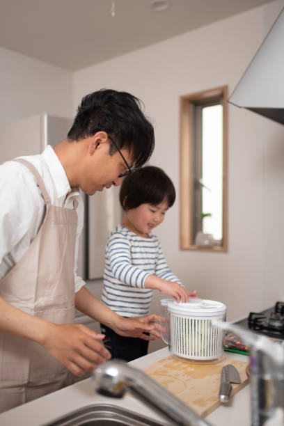 istock Father cooking in kitchen with his son 1138635175