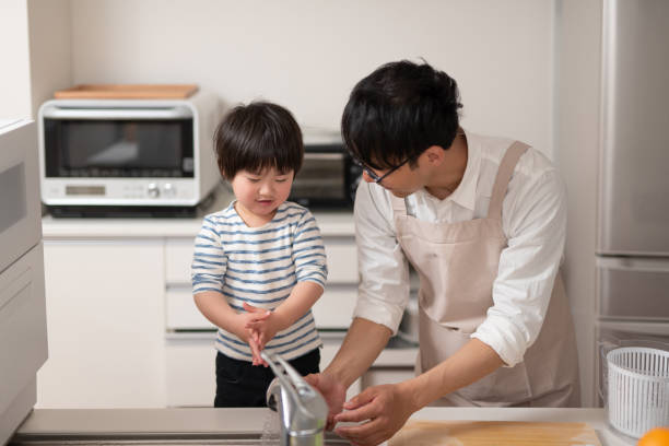 istock Father cooking in kitchen with his son 1138635319